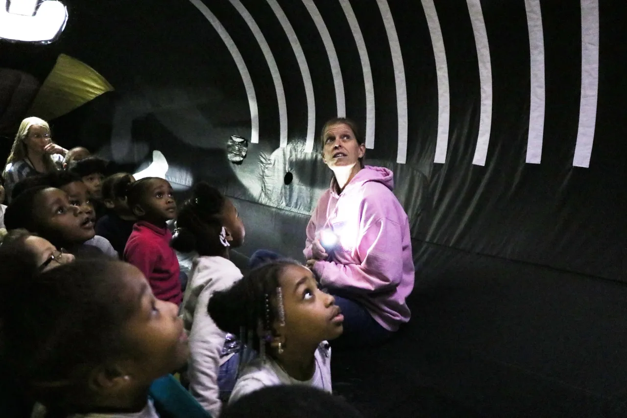 Students posing with the inflatable whale in their school gym