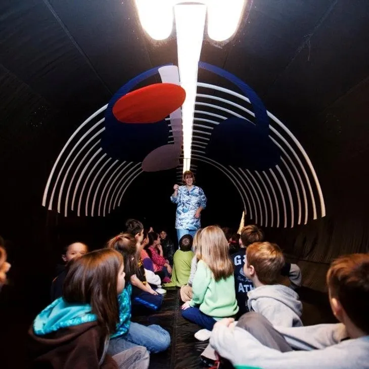 Students exploring an interactive whale exhibit